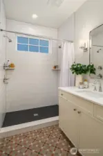 The main floor bath is graced by designer Italian tile flooring and luxe walk in shower.
