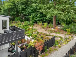 The home overlooks lushly planted common area and gardens featuring fruiting and flowering plantings. Fresh blueberries, anyone?