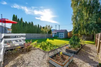 Fully fenced big yard w/ sauna, finished studio shed, garden space & more.