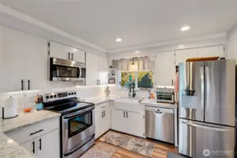 Tile backsplash, refinished cabinets & new farmhouse sink.
