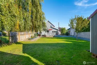 Oversized yard w/ mature landscaping & raised garden beds.