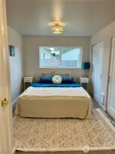 Primary with closet on left and wall of closets on the right