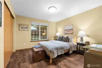 At the end of the hallway, a spacious bedroom offers comfort and quiet retreat.