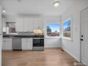 Eating space at corner windows and door to the deck.