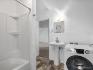 Upper level full bath with its washer/dryer.