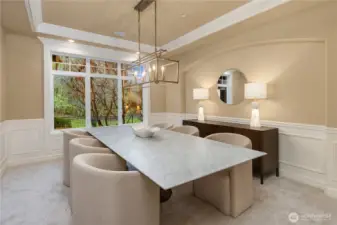 The formal dining room showcases the architectural details and finishes. Crown molding, wainscotting run throughout this home.