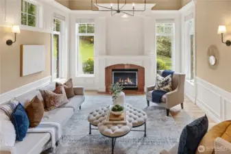 The formal living room with it's vaulted ceilings and high windows, perfectly frame the gorgeous wood and marble trimmed fireplace.