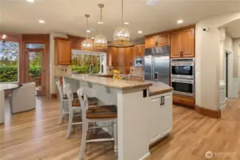 The gorgeous chef's kitchen has space for everyone. Chef grade appliances, six burner gas stove and double ovens.