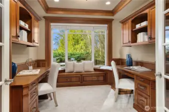 The rich hardwood desks/trim, coffered ceiling & window seat make for an elegant place to work from home.