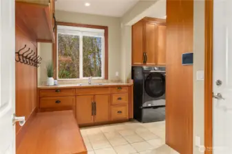 The main floor 'mud room' and laundry is the 'workhorse' of this home. Floor to ceiling cabinets galore, and cubbies and hooks for all.