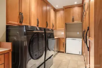 Another view of this huge room. Tile floors, multiple cabinets for storage and dual beverage fridges on the left.
