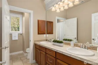 Upper floor full bath with double vanities.