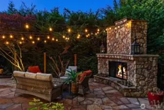 A stunning Rock gas fireplace with hearth is the centerpiece of the completely private outdoor space. Truly custom.