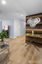 This crisp, icy palette flows uninterrupted from the ceiling to the baseboards, enveloping the gallery-style hallway, where smart layout reveals a discreetly positioned full bathroom and a spacious walk-in closet.