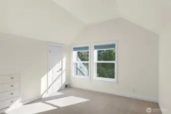 The upper-level enclave is defined by its architectural height and ethereal light, creating a series of bedrooms that feel like lofted retreats.