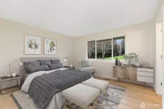 Spacious primary suite overlooks the back yard