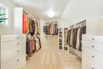 Spacious walk-in closet with built-in storage.