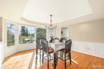 Formal dining room with hardwood floors off kitchen. View of cascade mountain range.