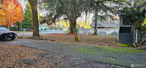 Entrance to the long and wide driveway and Spacious front yard.