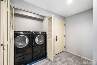 Laundry Closet with bifold doors  Frigidaire front load washer and dryer on matching pedestals with drawers  Waterproof Schluter-Kerdi membrane beneath tile