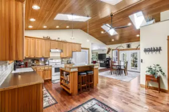 Be greeted by an open floor plan with vaulted ceilings and skylights