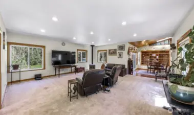 The spacious living room features a cozy wood stove