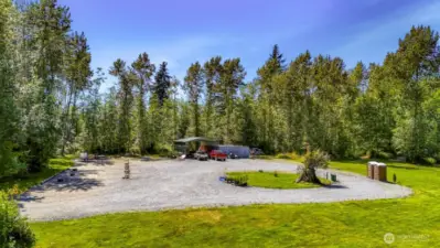 This large, flat parking area is a popular spot for RVs, Sprinter  Vans, and other campers. Outdoor toilets and washing station conveys