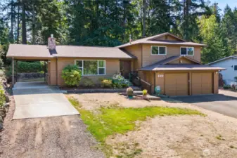 Attached carport on left, attached garage on right. Electric car charging, RV Hook ups, so much driveway space!
