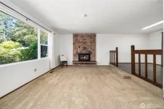 Main Floor Living room with fireplace and picture window