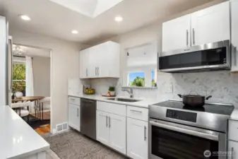 Updated kitchen in the center of the home; enter from hallway or dining room