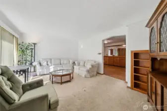 Front living room. There is hardwood underneath the carpet.