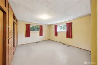 Primary bedroom with built-in closets and drawers