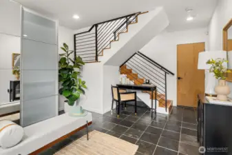 As you enter, gorgeous slate flooring greets you with a storage space that can be combined as a mud room and office nook, or workout space!