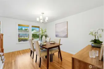 Wood floor flows through much of the downstairs, including the dining room.