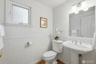 Downstairs powder room is a classic with wainscot and pedestal sink.