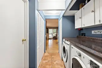 Main floor utility room has abundant storage.