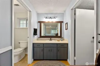 Private shower and toilet room to the left, the walk-in closet to your right.