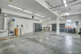 Spacious garage with workbenches and storage cabinets