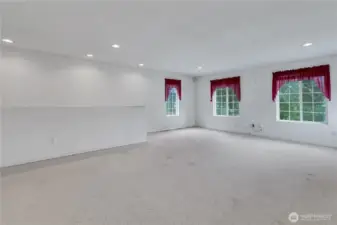 Enormous bonus room or media room. Rear staircase leads down to the family room