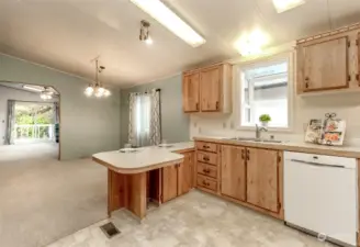 Kitchen view with the garden window and the dining room with the pass through into the family room.