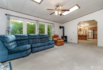 Spacious family room with lots of natural light through the large windows and sliding glass door.