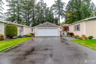 Ample parking in the driveway with sidewalk leading to wheelchair ramp and front door.