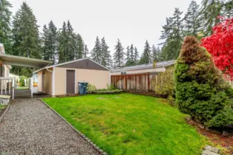 Back of the garage with pass through door and access to the side yard.