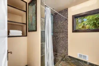 Designed with accessibility in mind, this bathroom includes an easy-entry shower and well-placed fixtures for a functional and welcoming experience.