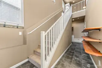 Entry to upstairs main living and are garage access.
