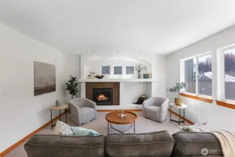 Den with fireplace and plenty of natural lighting
