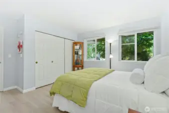 Primary Bedroom with huge closet and sunny windows that overlook the gardens