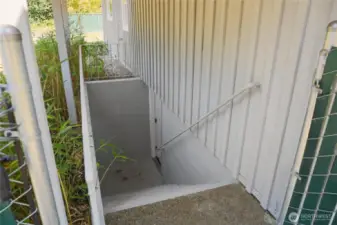 Seperate entrance for lower level of the home has shed roof covering for dry entry.