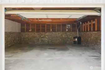 This feels like it could be more than a garage. It does have pellet stove heat and power. For the home mechanic is features a service pit.Love the rock skirting.