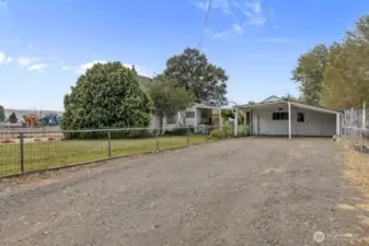 Driveway, carport and entrance to shop.
